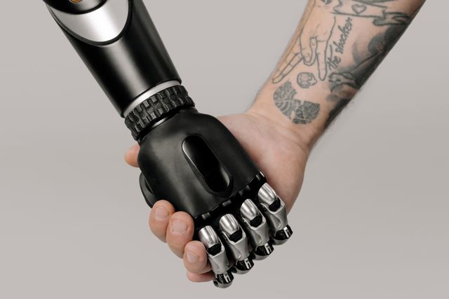 human and technology holding hands